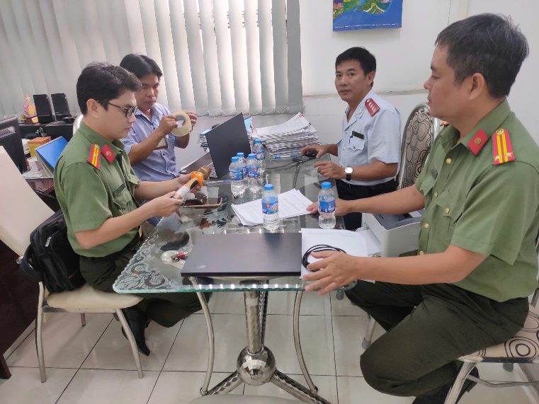 A group of men sitting around a table Description automatically generated